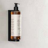 Flacon cu gel de duș și șampon din gama de cosmetice hoteliere Prija în suport de perete, pe perete